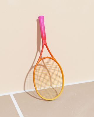 a yellow and pink tennis racket hanging on a wall