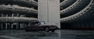 a car parked in front of a tall building