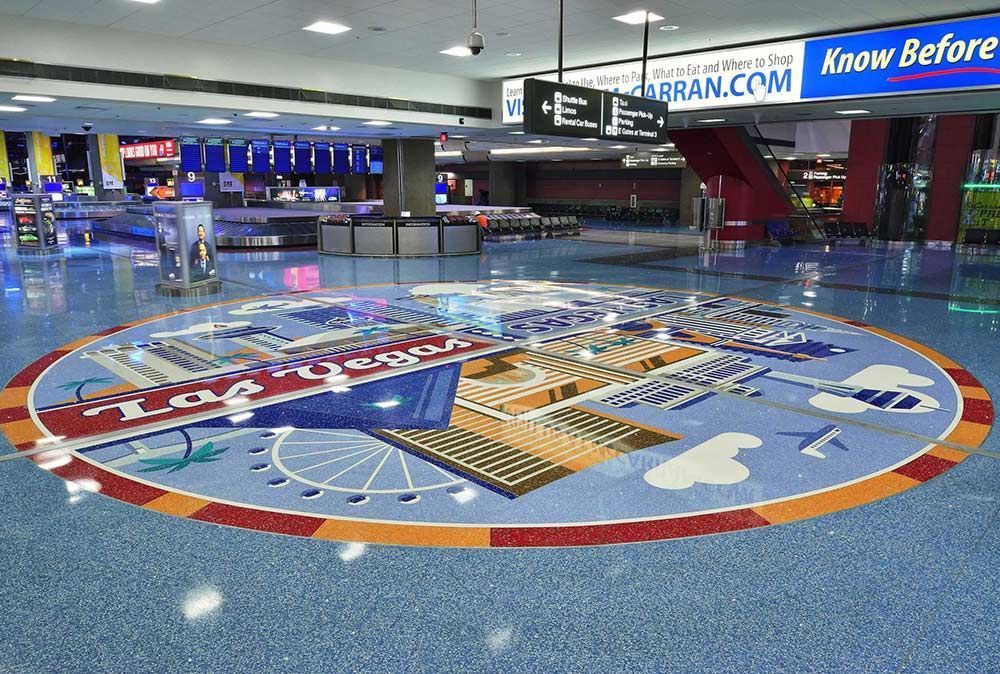 an airport lobby with a large circular sign on the floor