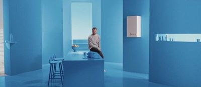 a man sitting on a counter in a blue room