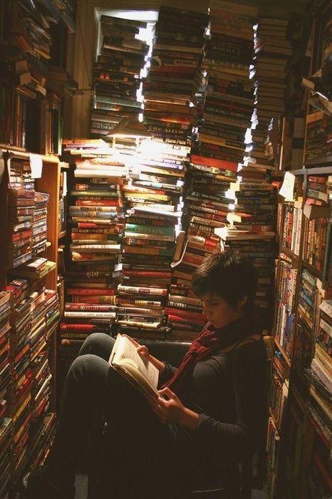 a woman sitting in a chair reading a book