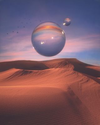 a large bubble floating in the air over a desert