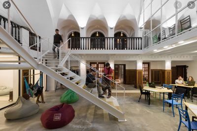 a group of people sitting at tables in a building