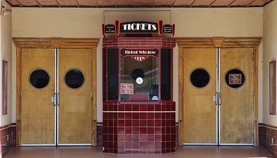 a building with three doors and a sign on the front of it