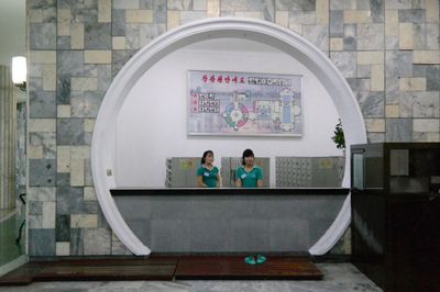 a couple of women standing in front of a counter