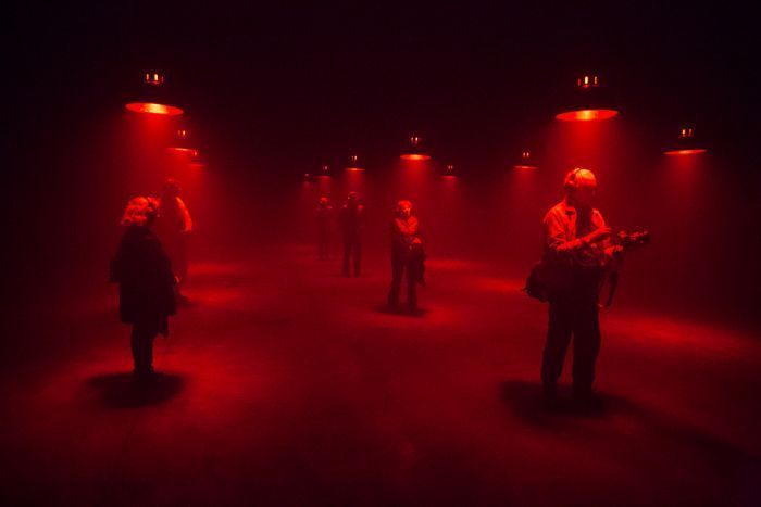 a group of people standing in a dark room