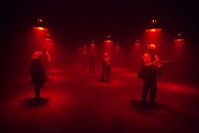 a group of people standing in a dark room