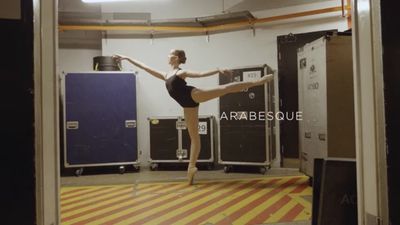 a woman in a black leotard is dancing