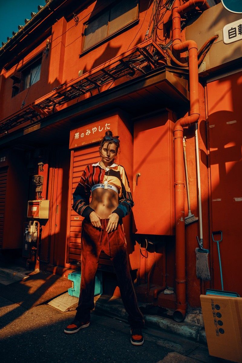 a man standing in front of a red building