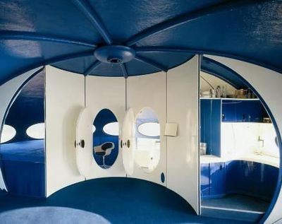 a blue and white room with a circular mirror