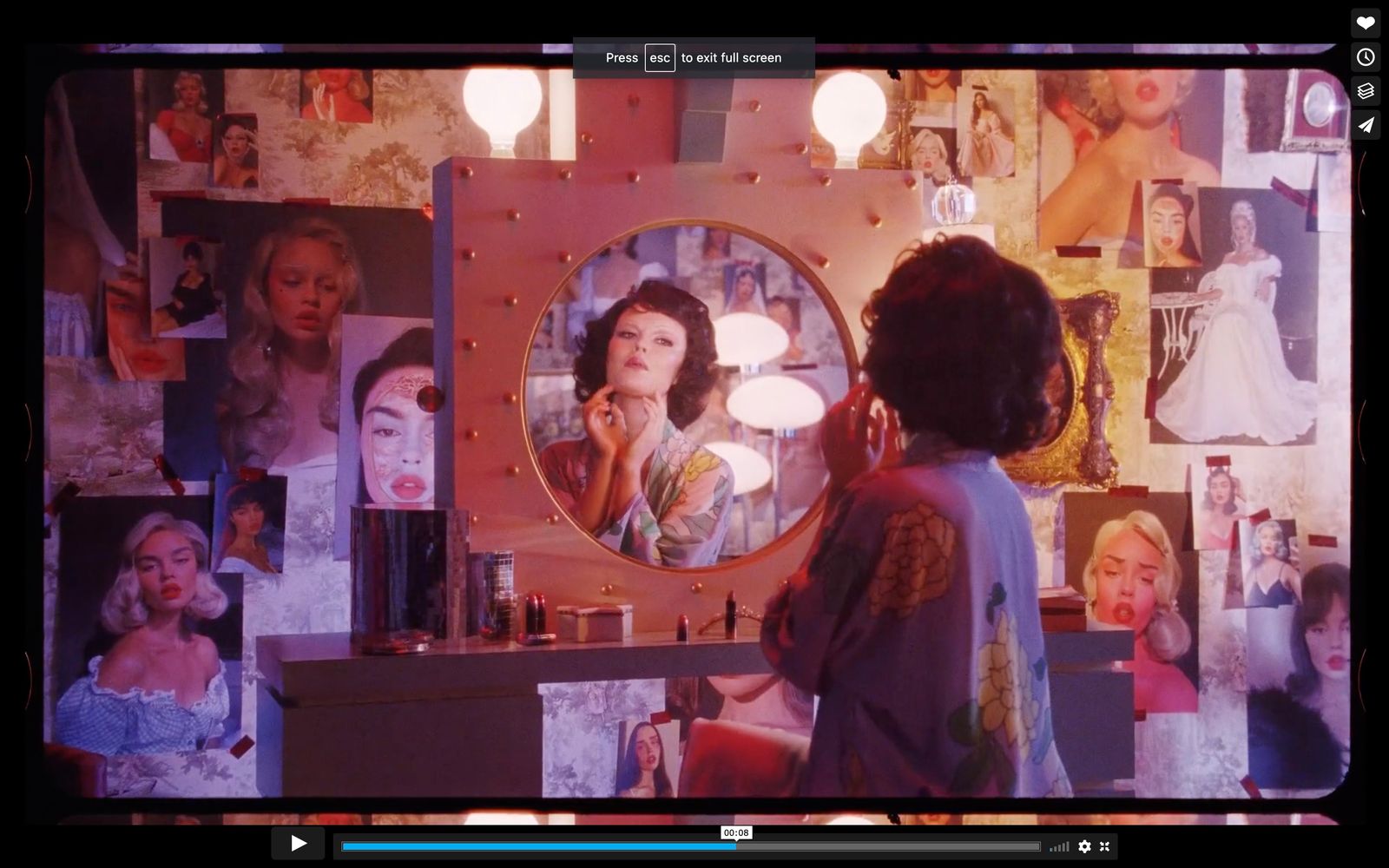 a woman standing in front of a vanity mirror