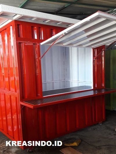 a red and green container with a shelf on top of it