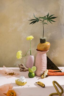 a table topped with a vase filled with flowers