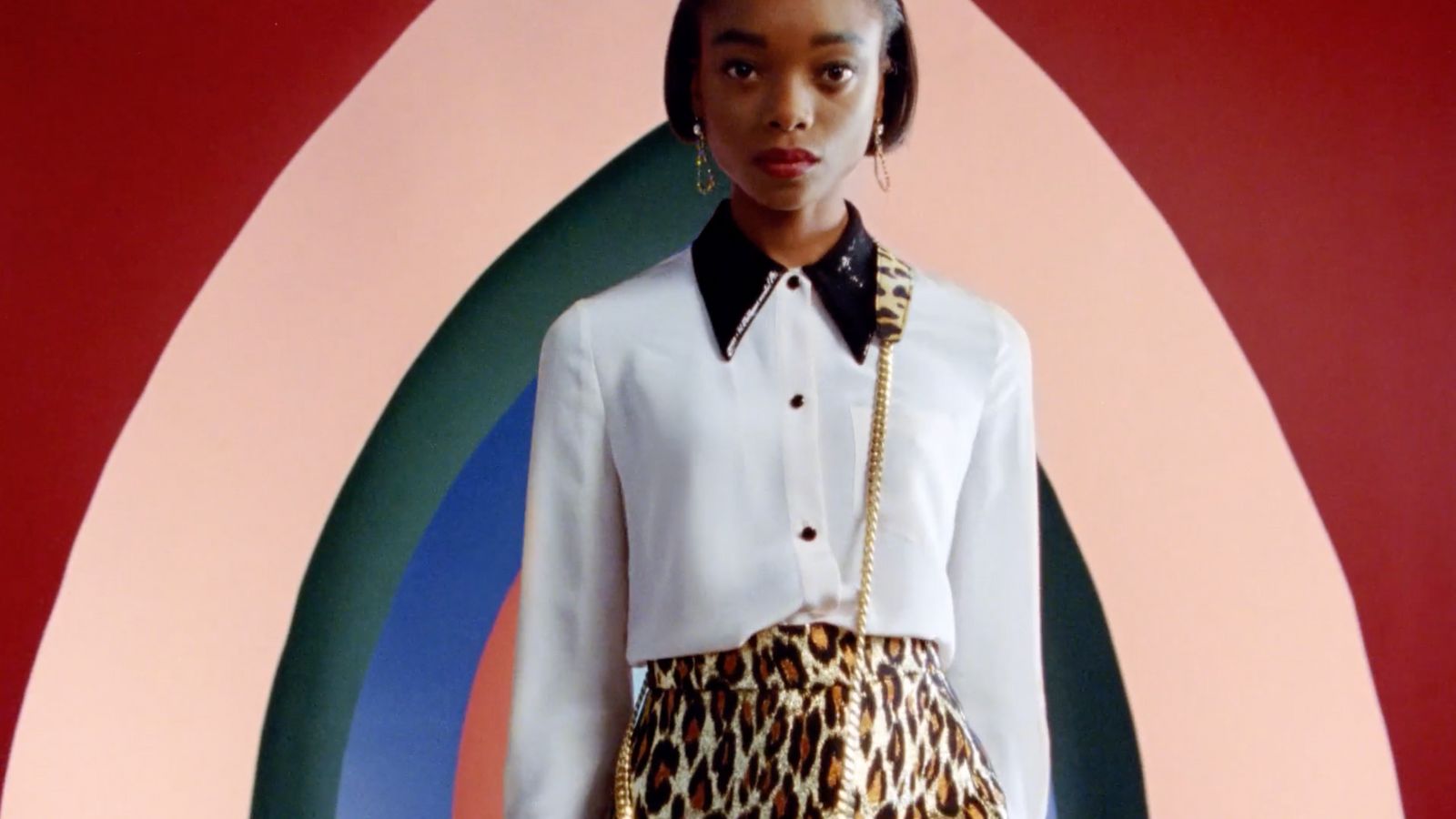 a woman in a white shirt and leopard print skirt