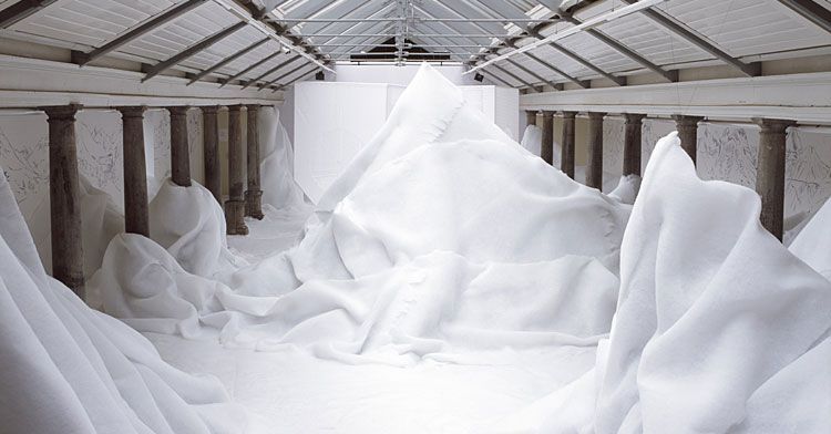 a room filled with lots of white fabric