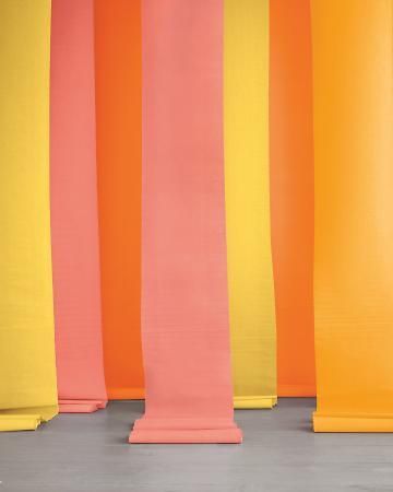 a woman standing in front of a row of colorful columns