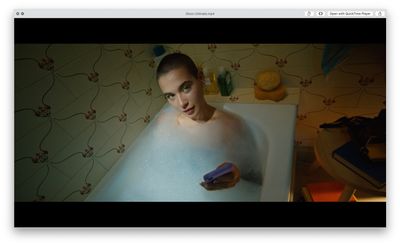 a woman in a bathtub holding a toothbrush