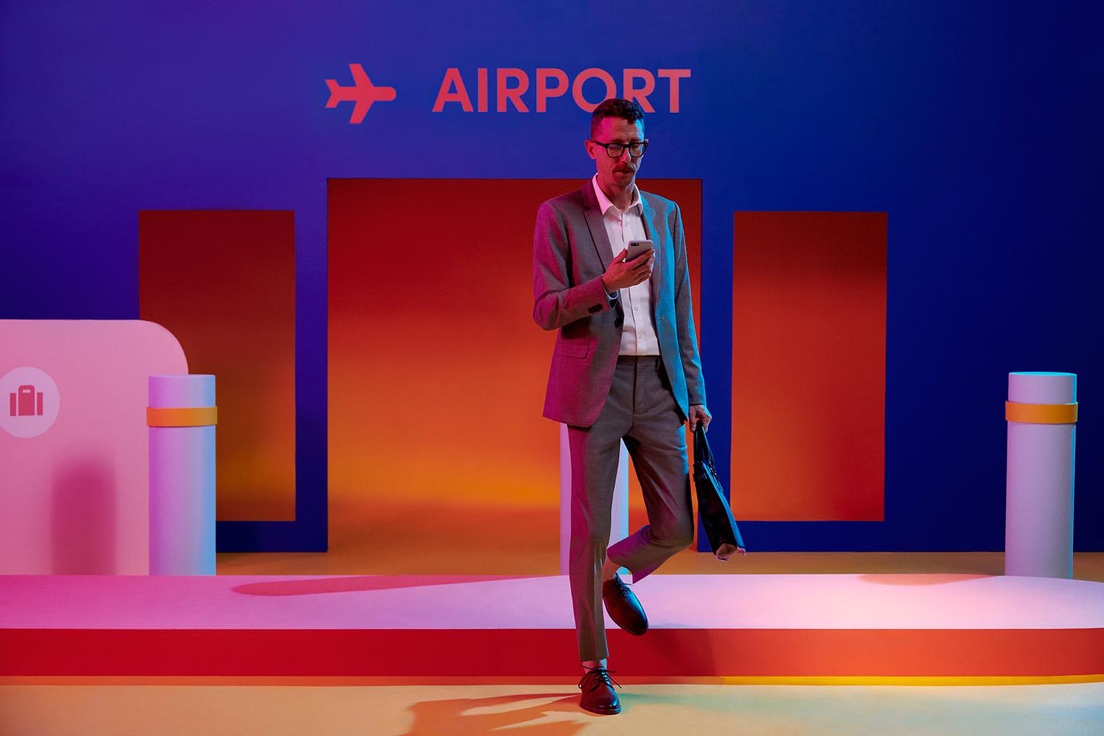 a man standing in front of an airport sign