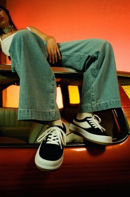 a woman sitting on the hood of a car