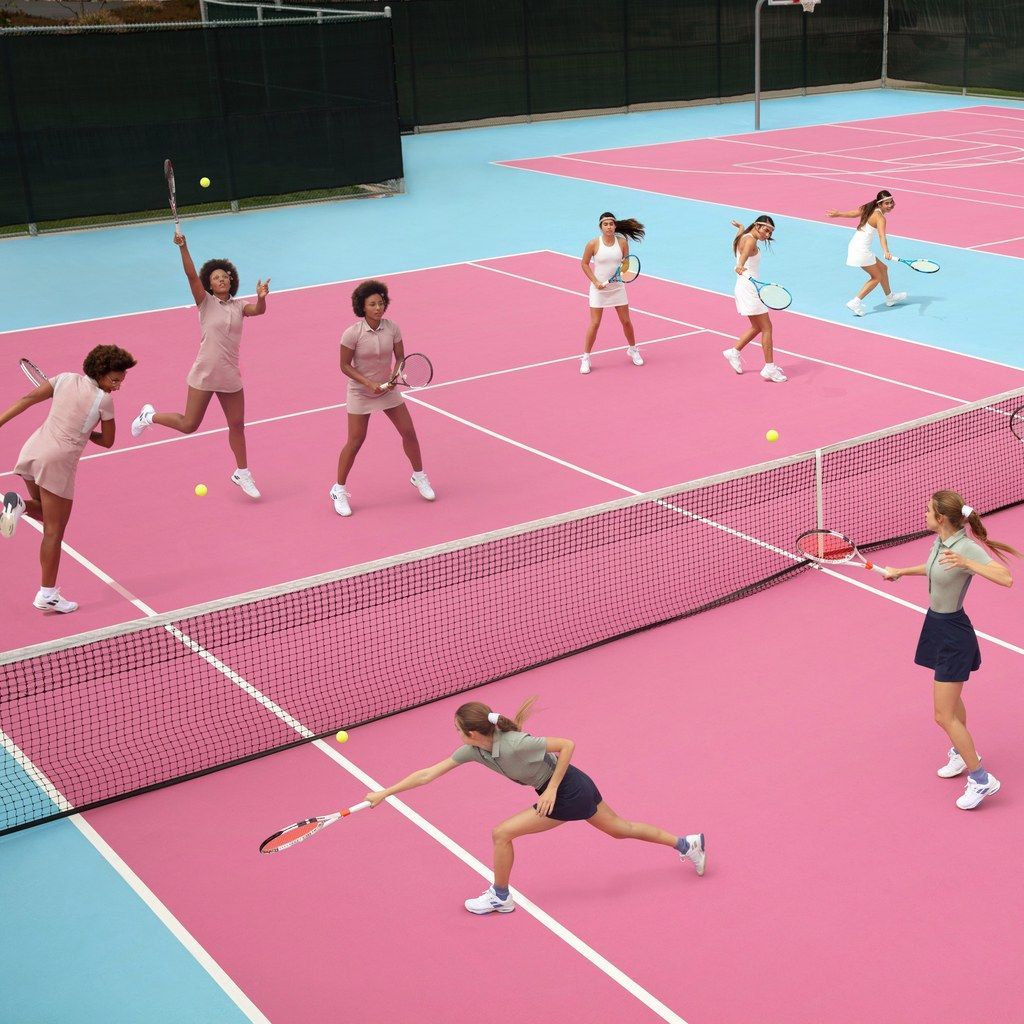 a group of women playing a game of tennis