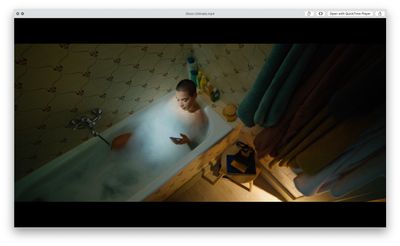 a man in a bathtub looking at his cell phone