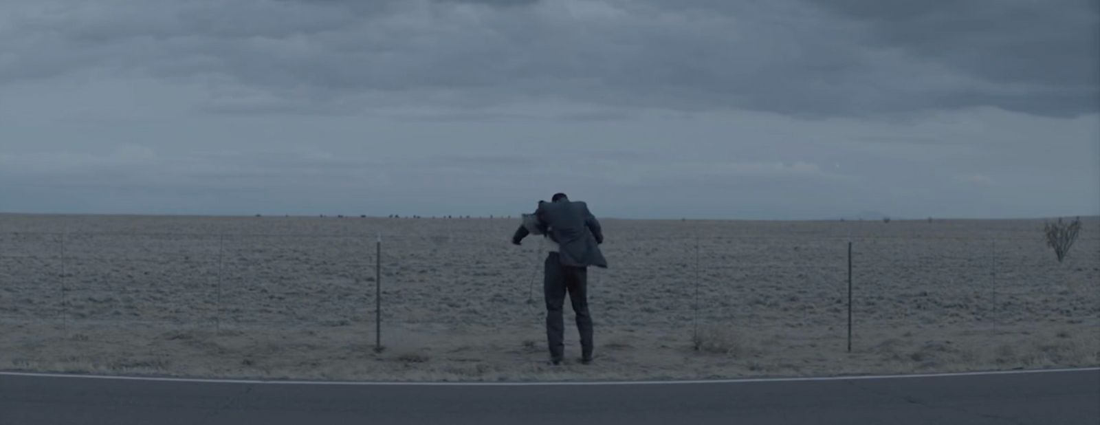 a man standing on the side of a road