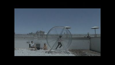 a man standing in front of a giant wheel