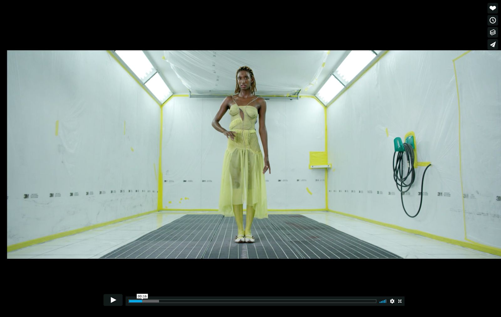 a woman in a yellow dress standing in a room