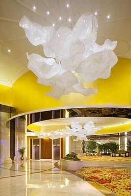 a large chandelier hanging from the ceiling of a hotel lobby