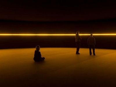 two people sitting on the floor in a dark room