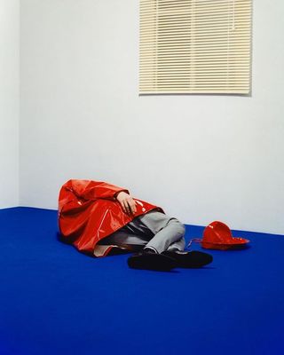 a person laying on a blue floor in a room