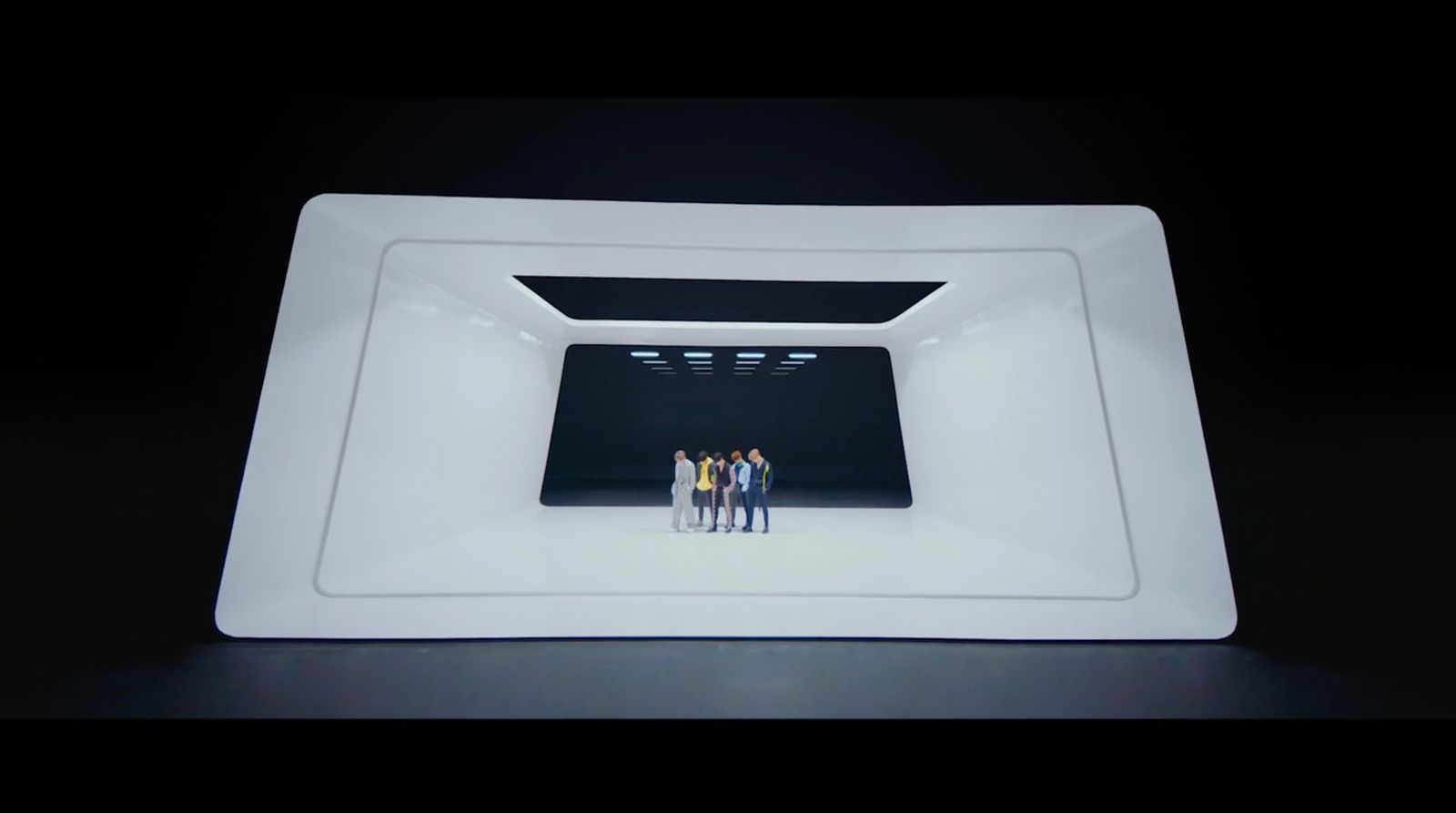 a group of people standing inside of a white bowl