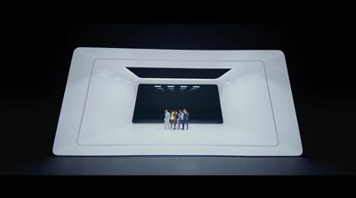 a group of people standing inside of a white bowl