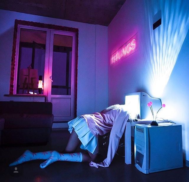 a woman laying on the floor next to a tv