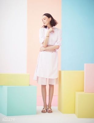 a woman standing in front of a colorful wall