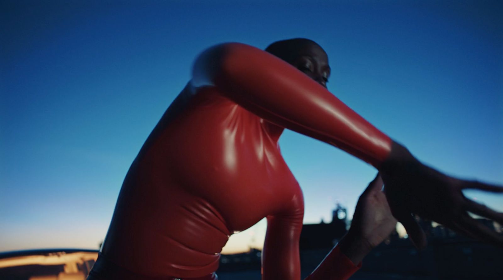 a man in a red leather outfit poses for a picture