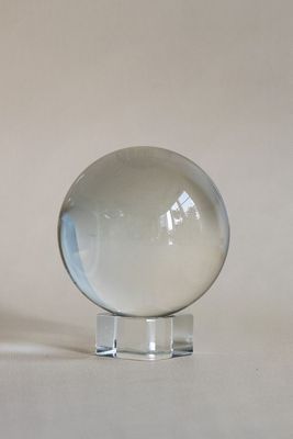 a clear glass ball sitting on top of a stand