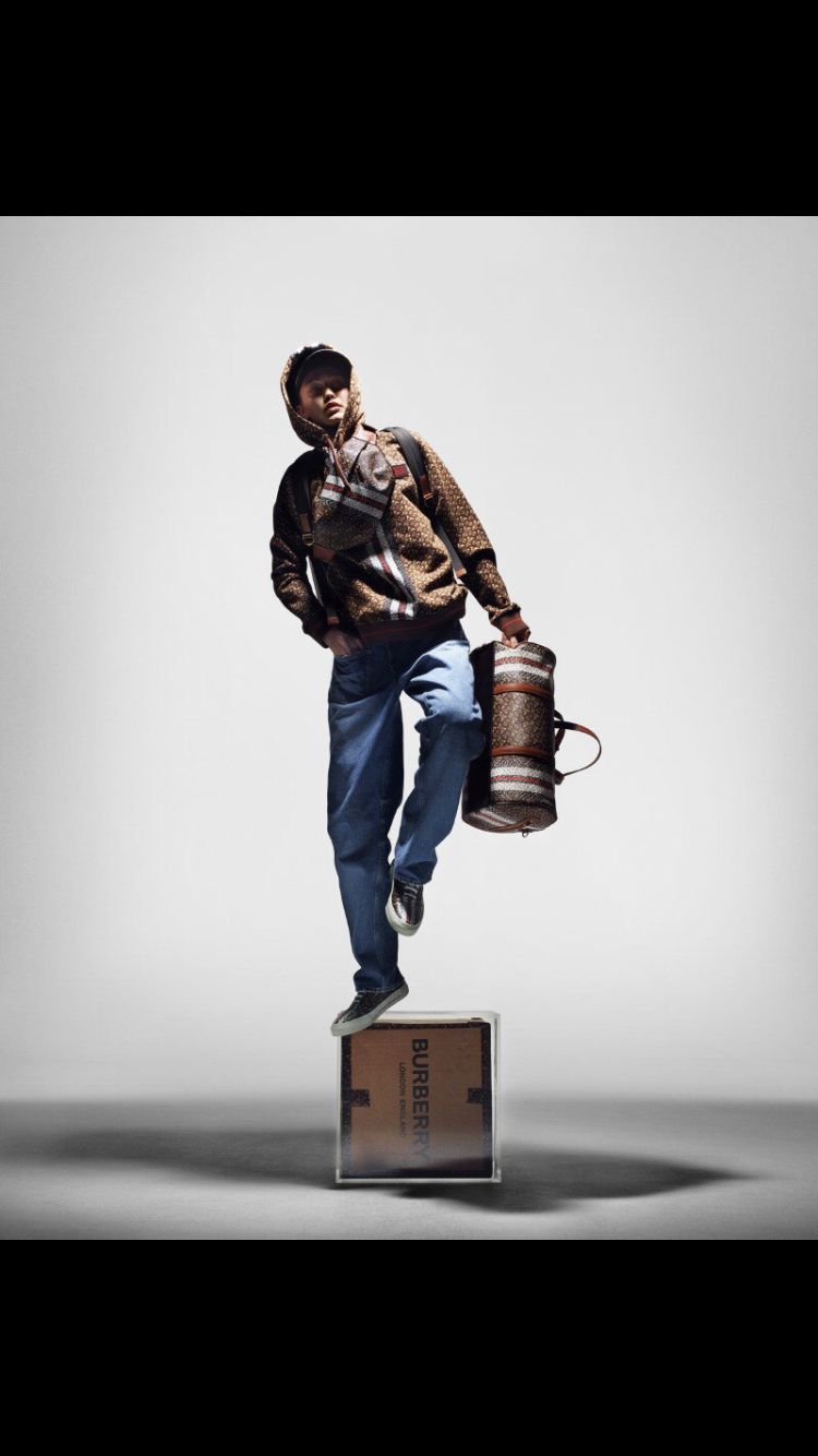 a man standing on top of a box holding a bucket