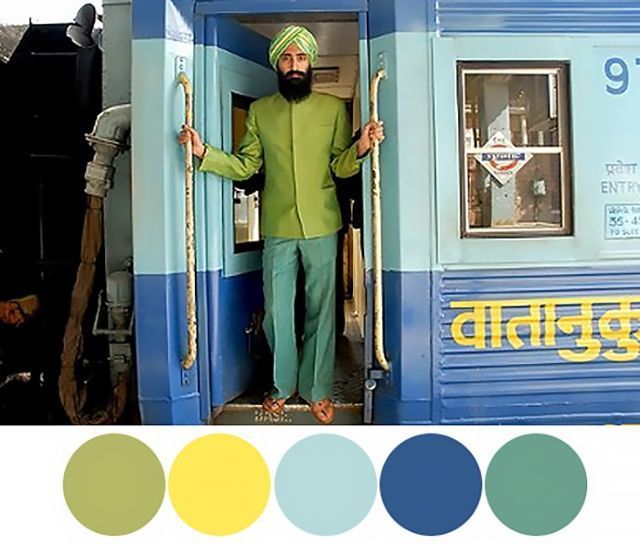 a man in a green outfit standing on a train