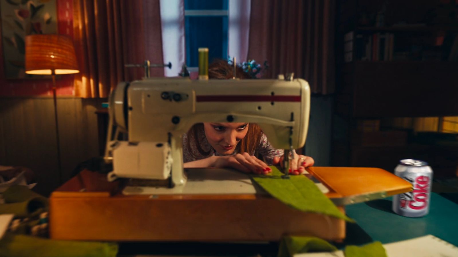 a woman is working on a sewing machine