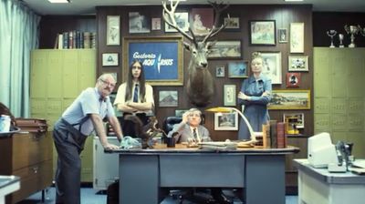 a group of people standing around a desk