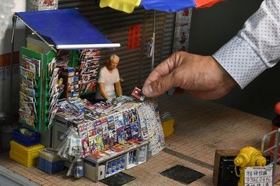 a man is putting money into a toy house