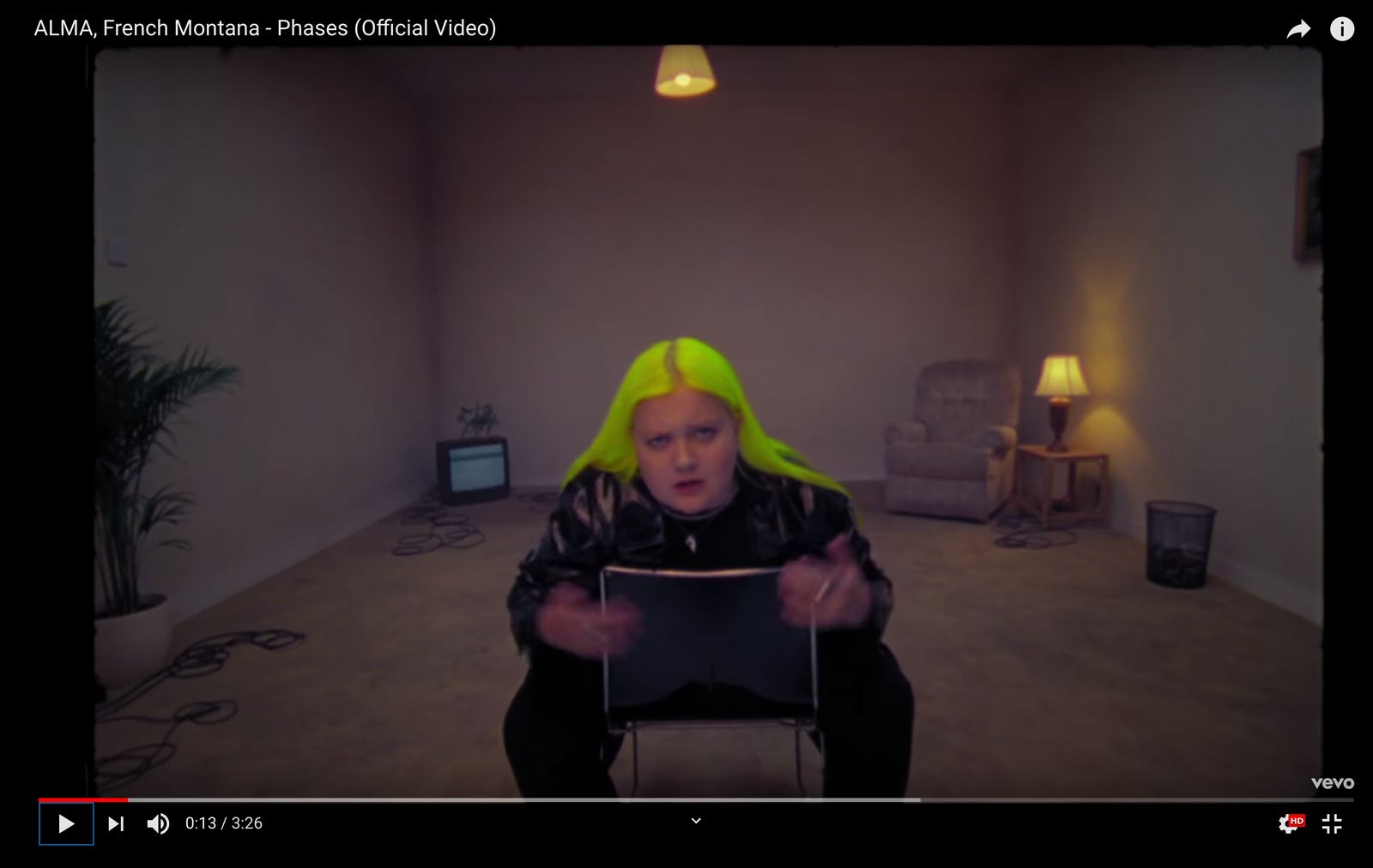 a person with yellow hair sitting in a room