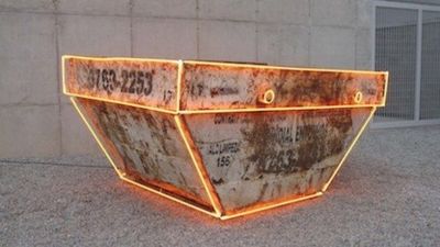 a rusted metal container sitting on top of a sidewalk