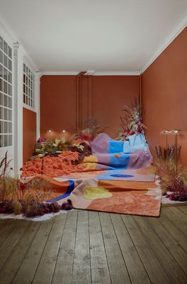 a room that has a bunch of different colored rugs on the floor