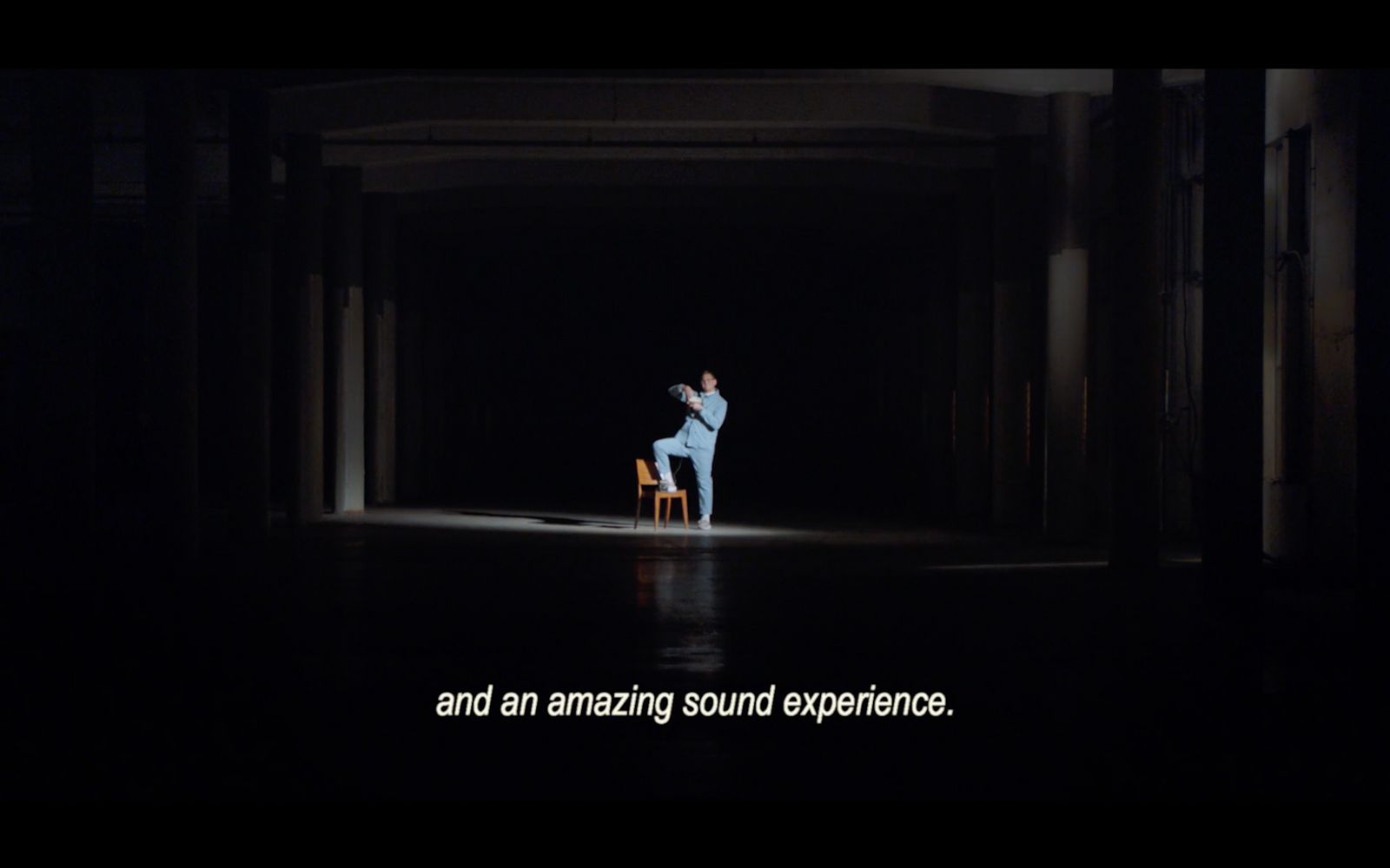 a person sitting on a chair in a dark room