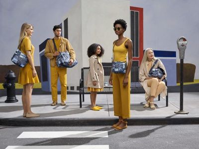 a group of people standing in front of a parking meter