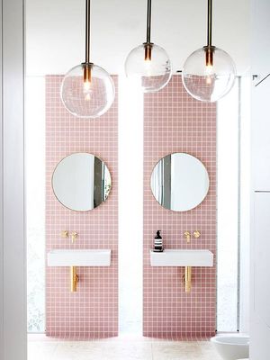 a bathroom with two sinks and two mirrors