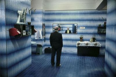 a man standing in a room with blue walls