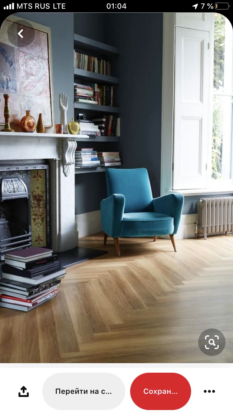 a living room with a blue chair and a fireplace